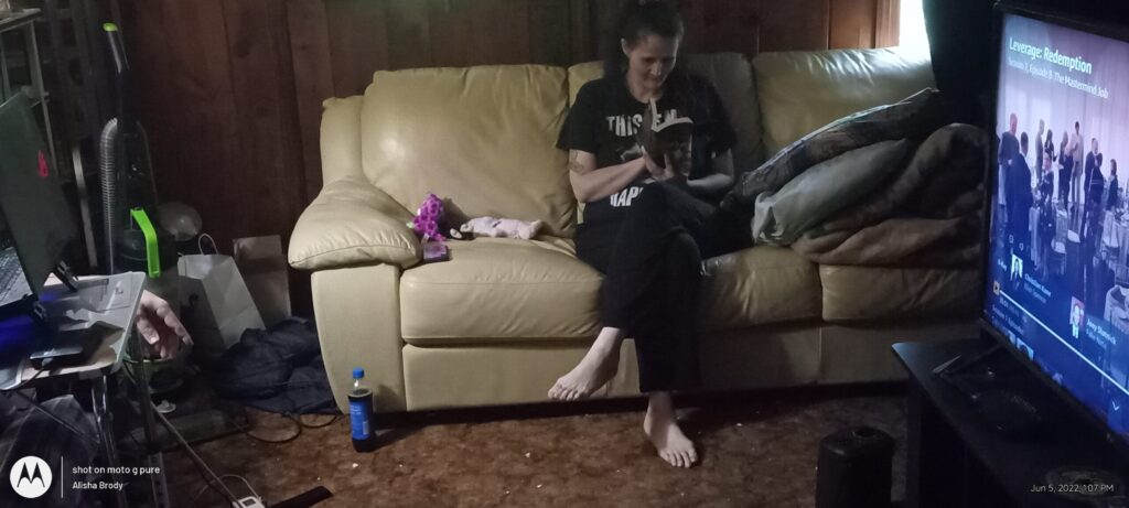 Author reading a book on the couch, reflecting how storytelling heals